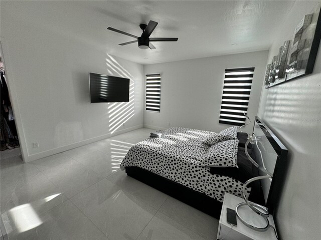 bedroom featuring ceiling fan and tile patterned floors