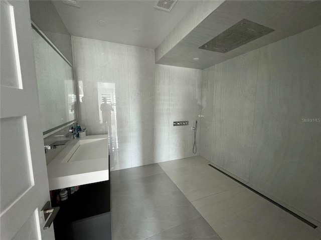 full bathroom with double vanity, visible vents, a sink, and tile patterned flooring