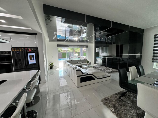 kitchen with black appliances and light tile patterned floors