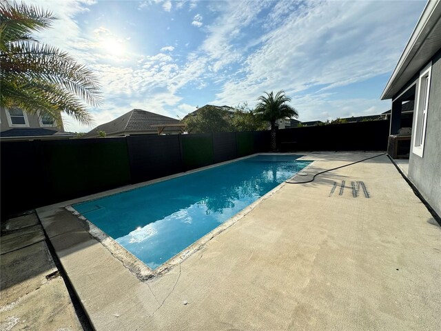 view of swimming pool with a patio