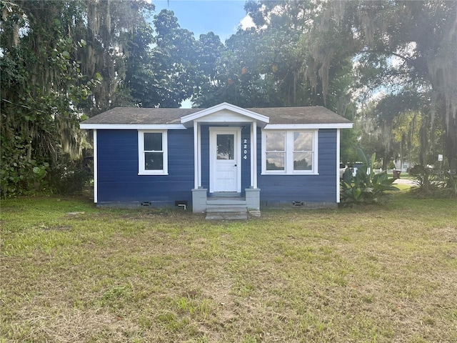 view of front of home featuring entry steps, crawl space, and a front yard