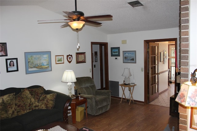 living room featuring dark hardwood / wood-style flooring, a textured ceiling, lofted ceiling, and ceiling fan