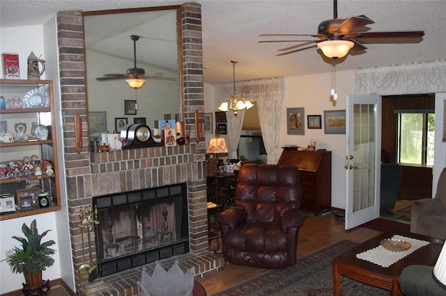 living room featuring dark hardwood / wood-style floors, brick wall, a fireplace, a textured ceiling, and lofted ceiling