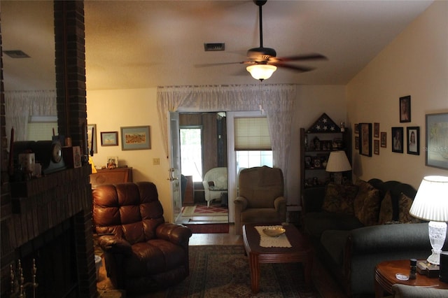 living room featuring ceiling fan and brick wall