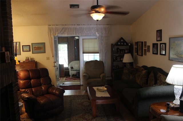 living room featuring ceiling fan and lofted ceiling