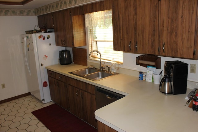 kitchen featuring sink, white fridge, and light tile patterned floors