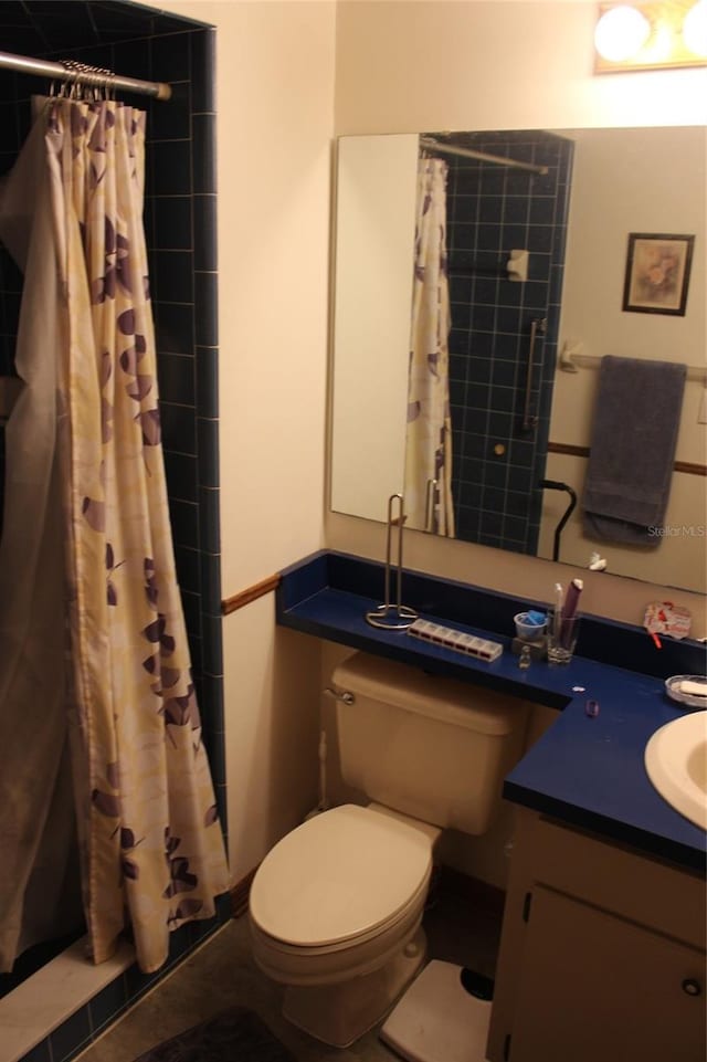 bathroom featuring toilet, a shower with shower curtain, vanity, and tile patterned floors