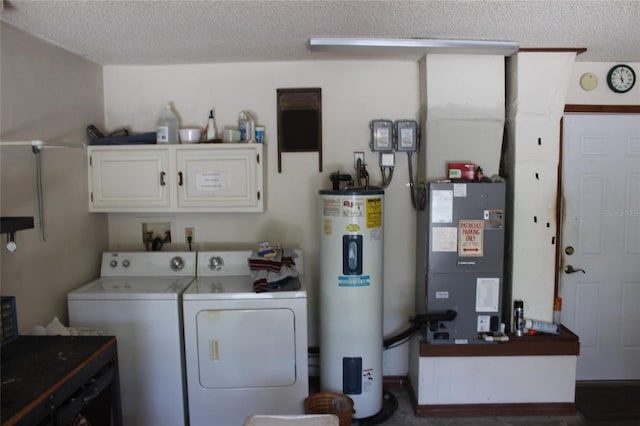 laundry area featuring washer and clothes dryer, cabinets, a textured ceiling, water heater, and heating unit