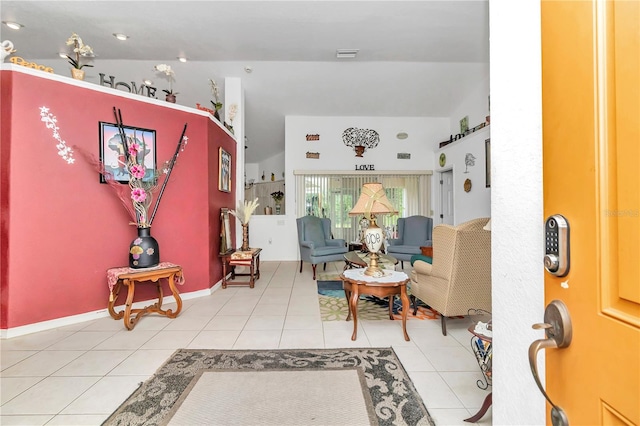 interior space featuring tile patterned flooring and vaulted ceiling