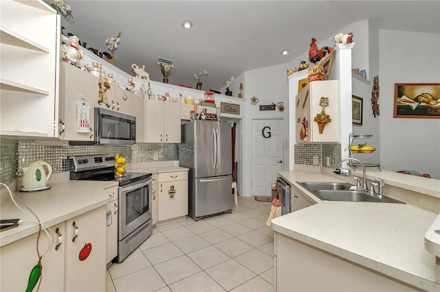 kitchen with decorative backsplash, sink, light tile patterned floors, and appliances with stainless steel finishes