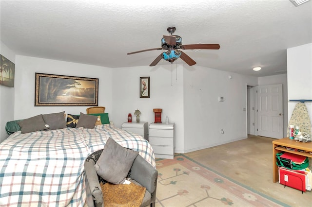 bedroom featuring ceiling fan, light colored carpet, and a textured ceiling