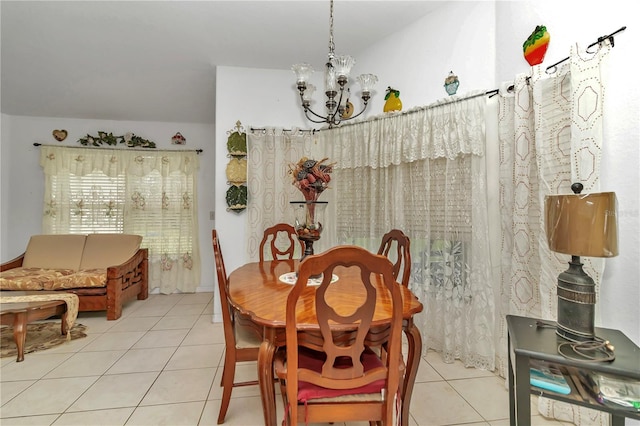 dining area with a notable chandelier and light tile patterned flooring