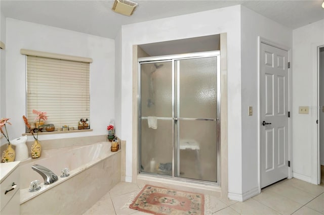 bathroom with tile patterned floors and independent shower and bath