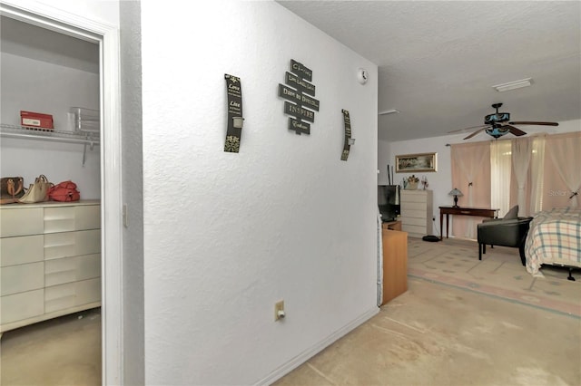 hallway with a textured ceiling