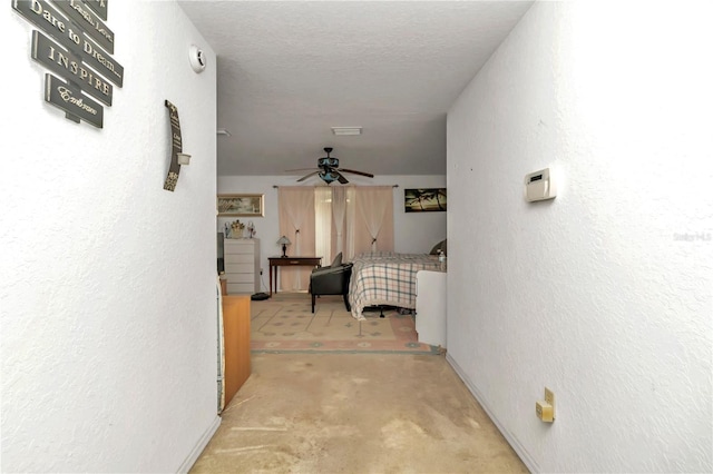 hall featuring a textured ceiling