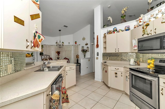 kitchen featuring decorative backsplash, appliances with stainless steel finishes, sink, a notable chandelier, and light tile patterned flooring