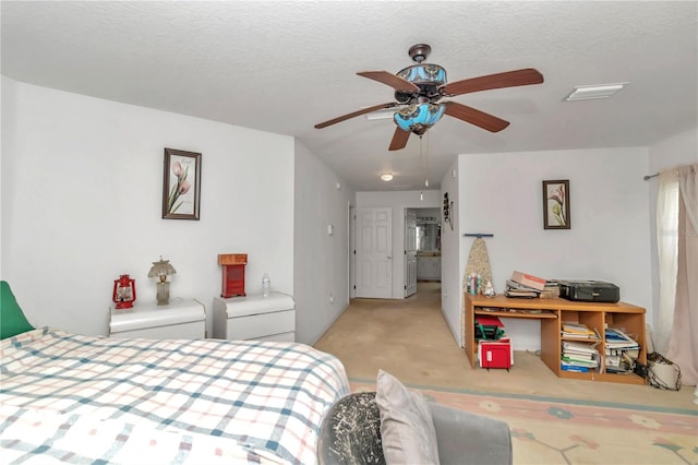 carpeted bedroom featuring lofted ceiling, ceiling fan, and a textured ceiling