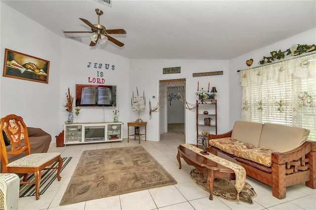 tiled living room with ceiling fan and vaulted ceiling