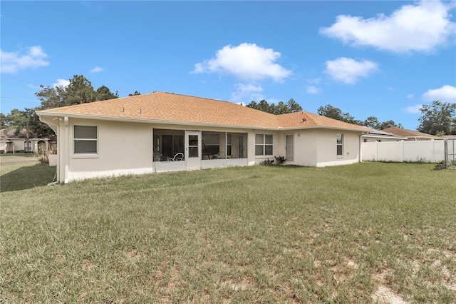 rear view of house with a lawn