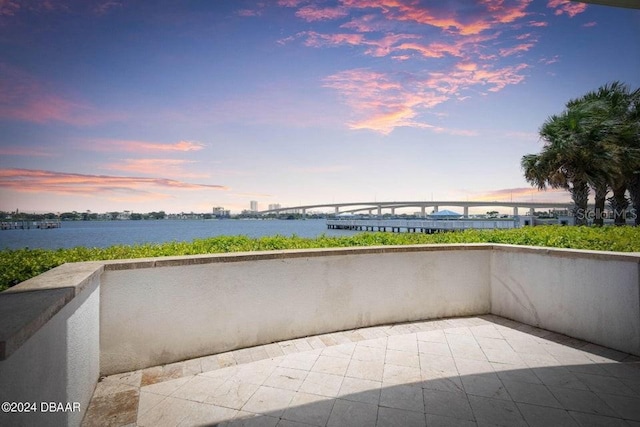 231 Riverside Dr Unit 101-1, Holly Hill, FL 32117 - balcony at dusk featuring a water view