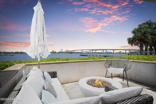 231 Riverside Dr Unit 101-1, Holly Hill, FL 32117 - view of patio with a water view and an outdoor living space with a fire pit