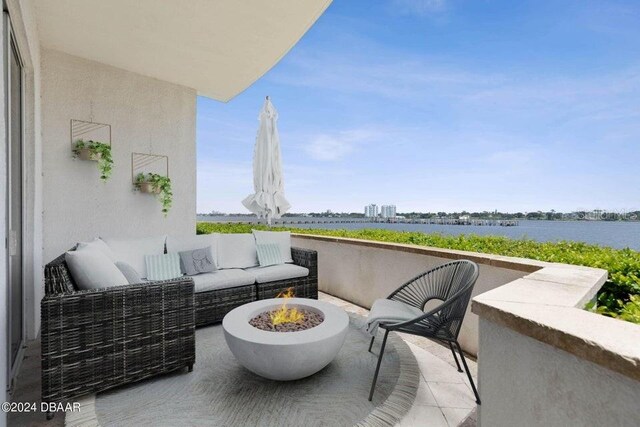 231 Riverside Dr Unit 101-1, Holly Hill, FL 32117 - balcony featuring an outdoor living space with a fire pit, a patio area, and a water view