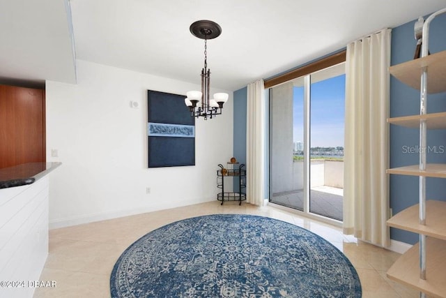 231 Riverside Dr Unit 101-1, Holly Hill, FL 32117 - dining area featuring tile patterned floors, a chandelier, and baseboards