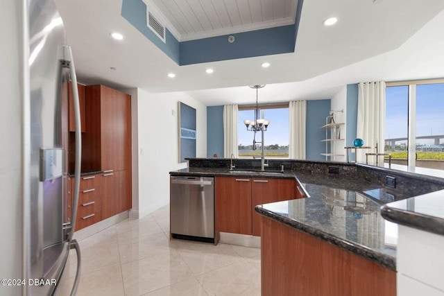 231 Riverside Dr Unit 101-1, Holly Hill, FL 32117 - kitchen with appliances with stainless steel finishes, a raised ceiling, modern cabinets, brown cabinets, and recessed lighting
