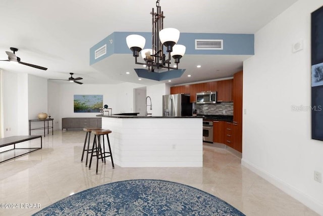 231 Riverside Dr Unit 101-1, Holly Hill, FL 32117 - kitchen featuring stainless steel appliances, dark countertops, backsplash, light tile patterned floors, and recessed lighting
