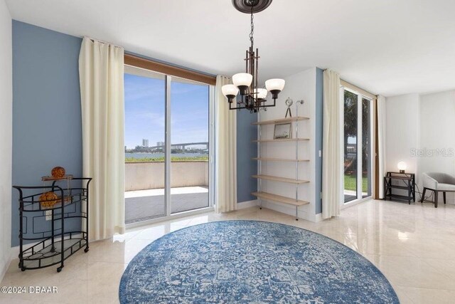 231 Riverside Dr Unit 101-1, Holly Hill, FL 32117 - dining area featuring a chandelier, tile patterned floors, and baseboards