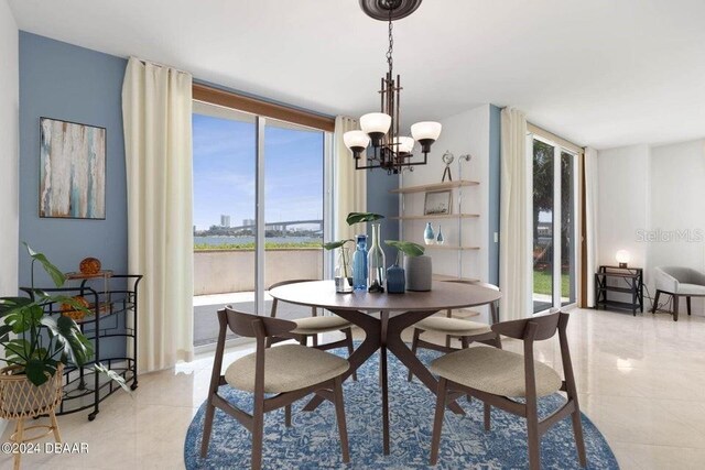 231 Riverside Dr Unit 101-1, Holly Hill, FL 32117 - dining room with healthy amount of natural light, light tile patterned flooring, and a chandelier