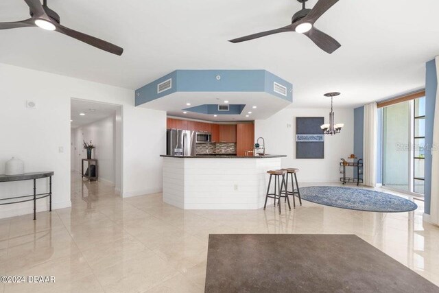 231 Riverside Dr Unit 101-1, Holly Hill, FL 32117 - living room featuring ceiling fan, a chandelier, and baseboards