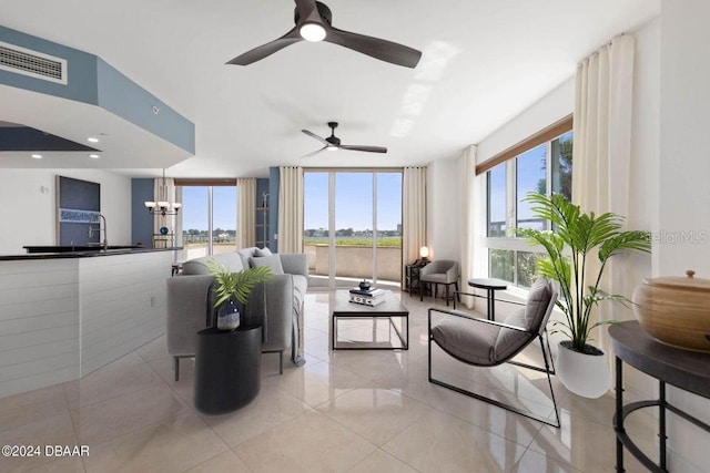 231 Riverside Dr Unit 101-1, Holly Hill, FL 32117 - living room featuring light tile patterned floors, ceiling fan, and a chandelier