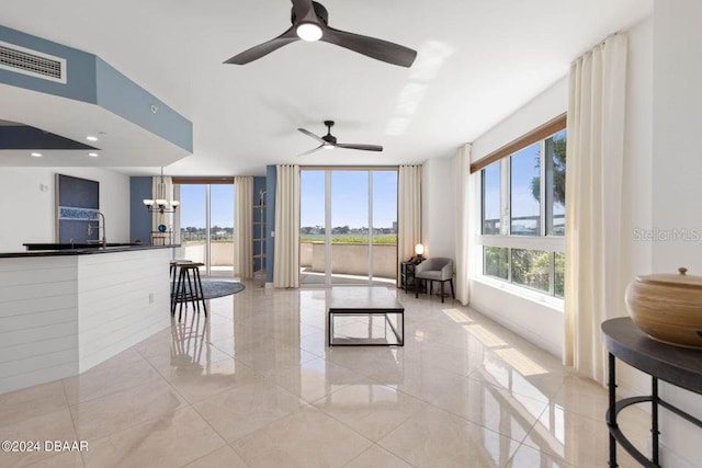 231 Riverside Dr Unit 101-1, Holly Hill, FL 32117 - living area with a ceiling fan, light tile patterned floors, and a chandelier