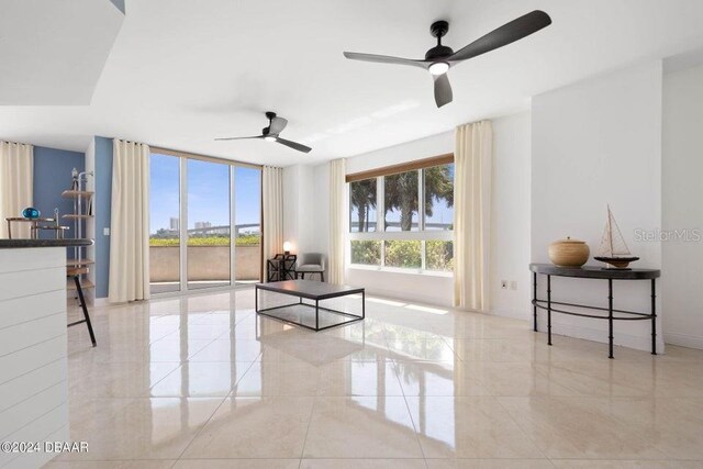 231 Riverside Dr Unit 101-1, Holly Hill, FL 32117 - living room with a ceiling fan, tile patterned floors, and baseboards