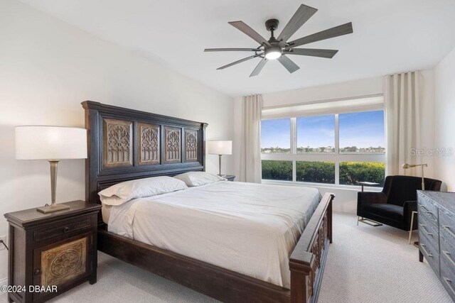 231 Riverside Dr Unit 101-1, Holly Hill, FL 32117 - bedroom featuring light colored carpet and a ceiling fan