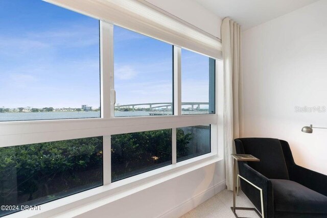 231 Riverside Dr Unit 101-1, Holly Hill, FL 32117 - sitting room with healthy amount of natural light, a water view, and carpet