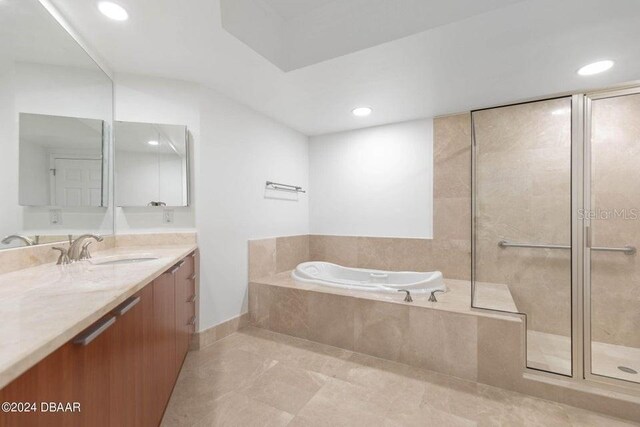 231 Riverside Dr Unit 101-1, Holly Hill, FL 32117 - bathroom featuring a garden tub, vanity, a stall shower, recessed lighting, and baseboards