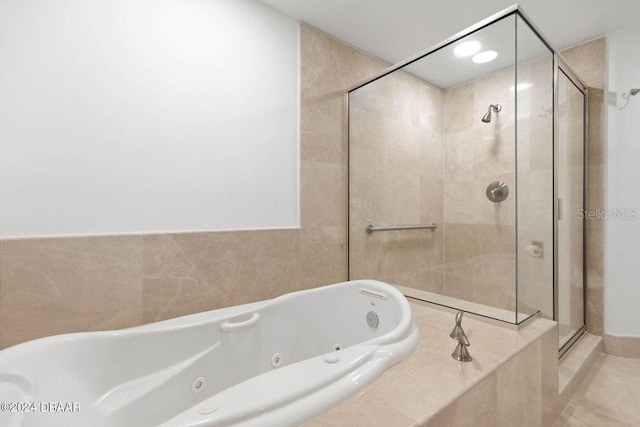 231 Riverside Dr Unit 101-1, Holly Hill, FL 32117 - bathroom featuring a stall shower and a whirlpool tub