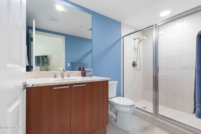 231 Riverside Dr Unit 101-1, Holly Hill, FL 32117 - bathroom featuring a stall shower, toilet, vanity, and tile patterned floors