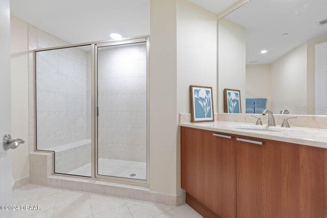 231 Riverside Dr Unit 101-1, Holly Hill, FL 32117 - bathroom featuring a stall shower, baseboards, vanity, tile patterned flooring, and recessed lighting