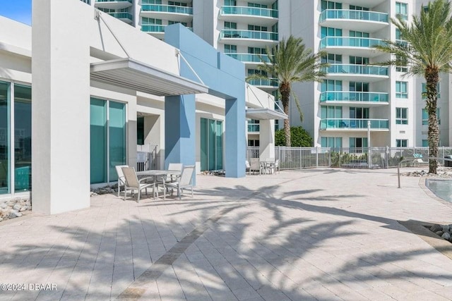 231 Riverside Dr Unit 101-1, Holly Hill, FL 32117 - view of patio featuring fence and outdoor dining area