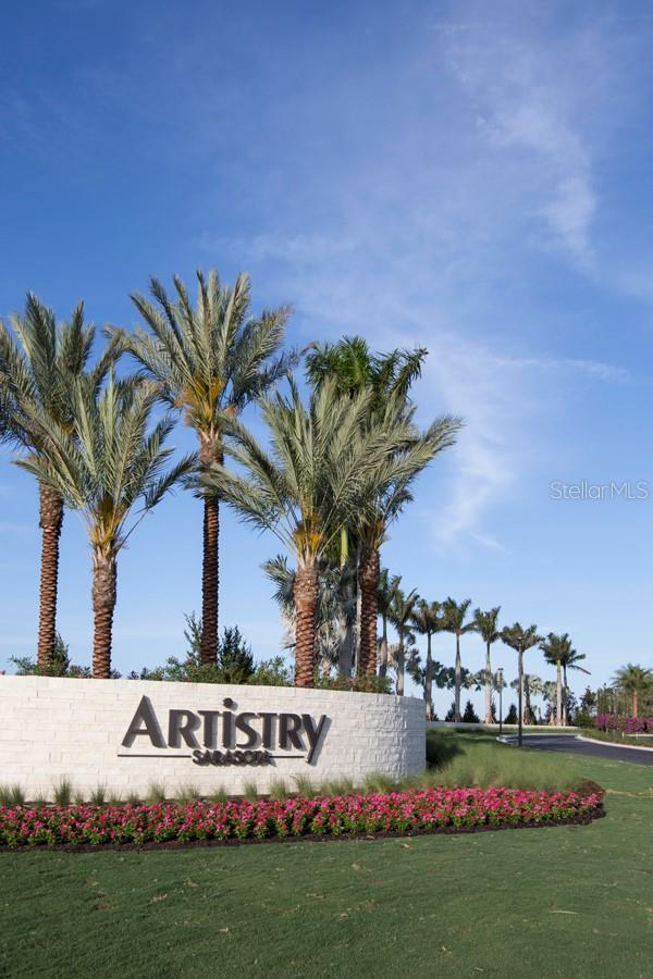 community sign featuring a lawn