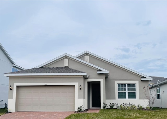 view of front facade with a garage and a front yard