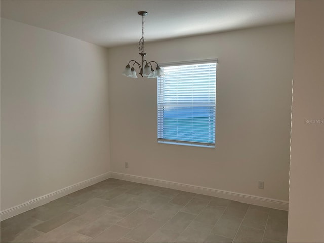 empty room featuring an inviting chandelier