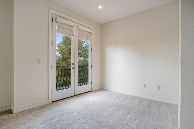 carpeted spare room with french doors