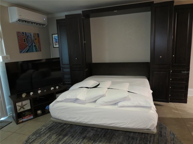 bedroom featuring light tile patterned floors, ornamental molding, and a wall mounted air conditioner