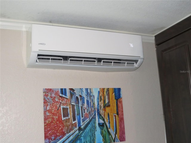 details featuring a textured ceiling and a wall mounted AC