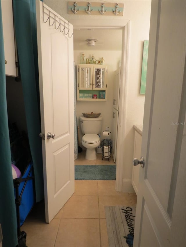 bathroom featuring vanity, toilet, and tile patterned floors