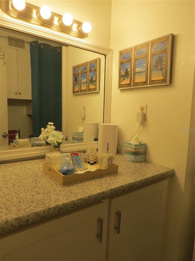 bathroom featuring visible vents and vanity